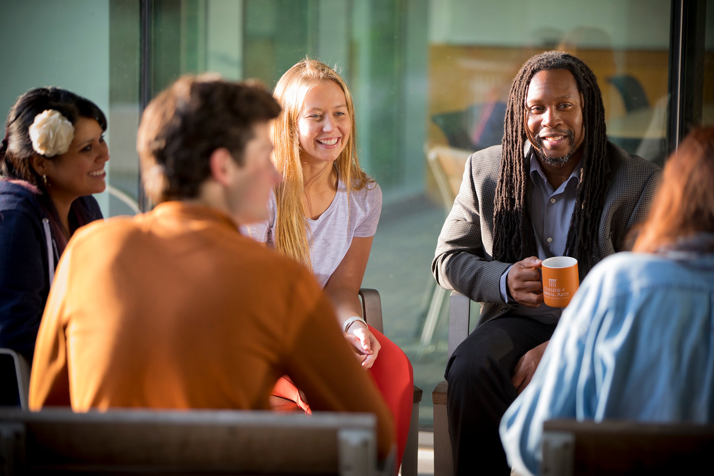 A group of students sitting with a faculty member